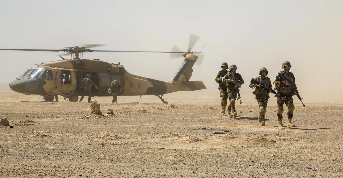 HELMAND PROVINCE, Afghanistan (July 15, 2018) -Soldiers with 2nd Kandak, 2nd Brigade, Afghan National Army 215th Corps disembark an Afghan Air Force (AAF) UH-60 Black Hawk during a troop re-supply at Camp Shorabak. The soldiers participated in their final training exercise of the Operational Readiness Cycle, which included support by indirect fire and troop re-supply from Afghan Air Force UH-60 Black Hawk.  Upon conclusion of the final exercise, they will re-enter the battle space to conduct offensive operations against the enemy. (U.S. Marine Corps photo by 1st Lt. Kathleen Kochert/Released)