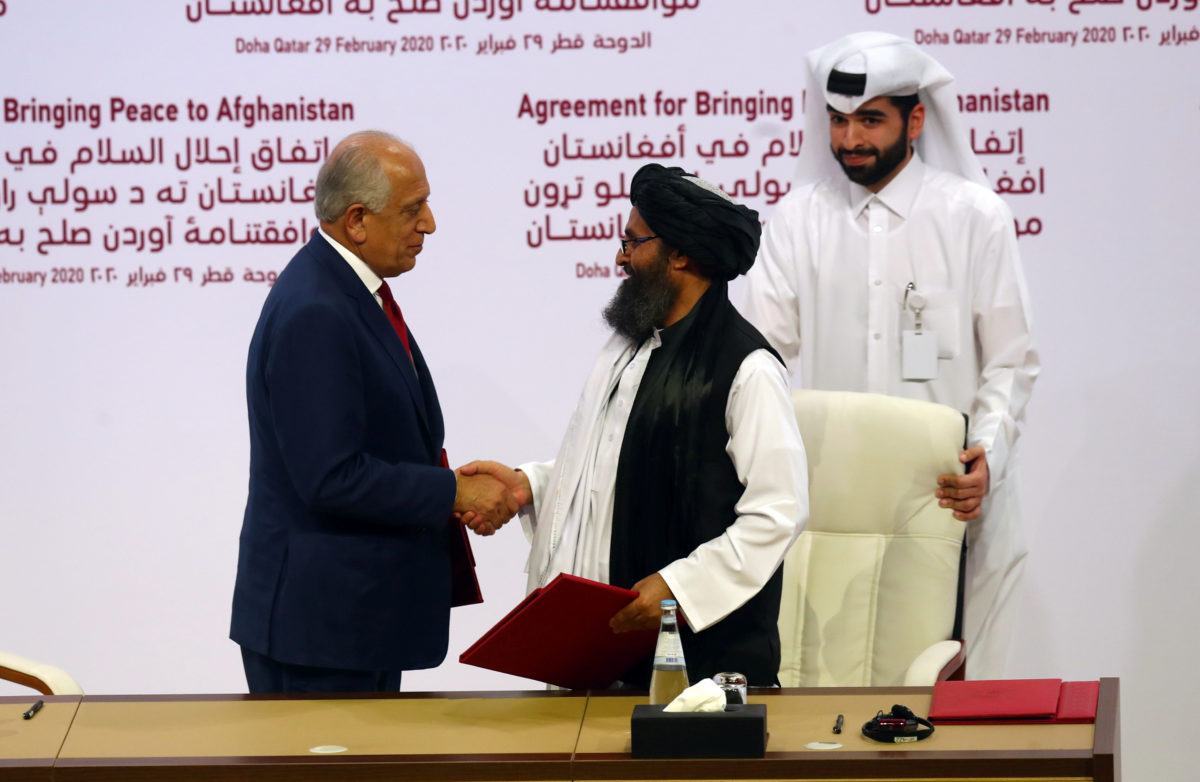 Mullah Abdul Ghani Baradar, the leader of the Taliban delegation, and Zalmay Khalilzad, U.S. envoy for peace in Afghanistan, shake hands after signing an agreement at a ceremony between members of Afghanistan's Taliban and the U.S. in Doha, Qatar February 29, 2020. REUTERS/Ibraheem al Omari